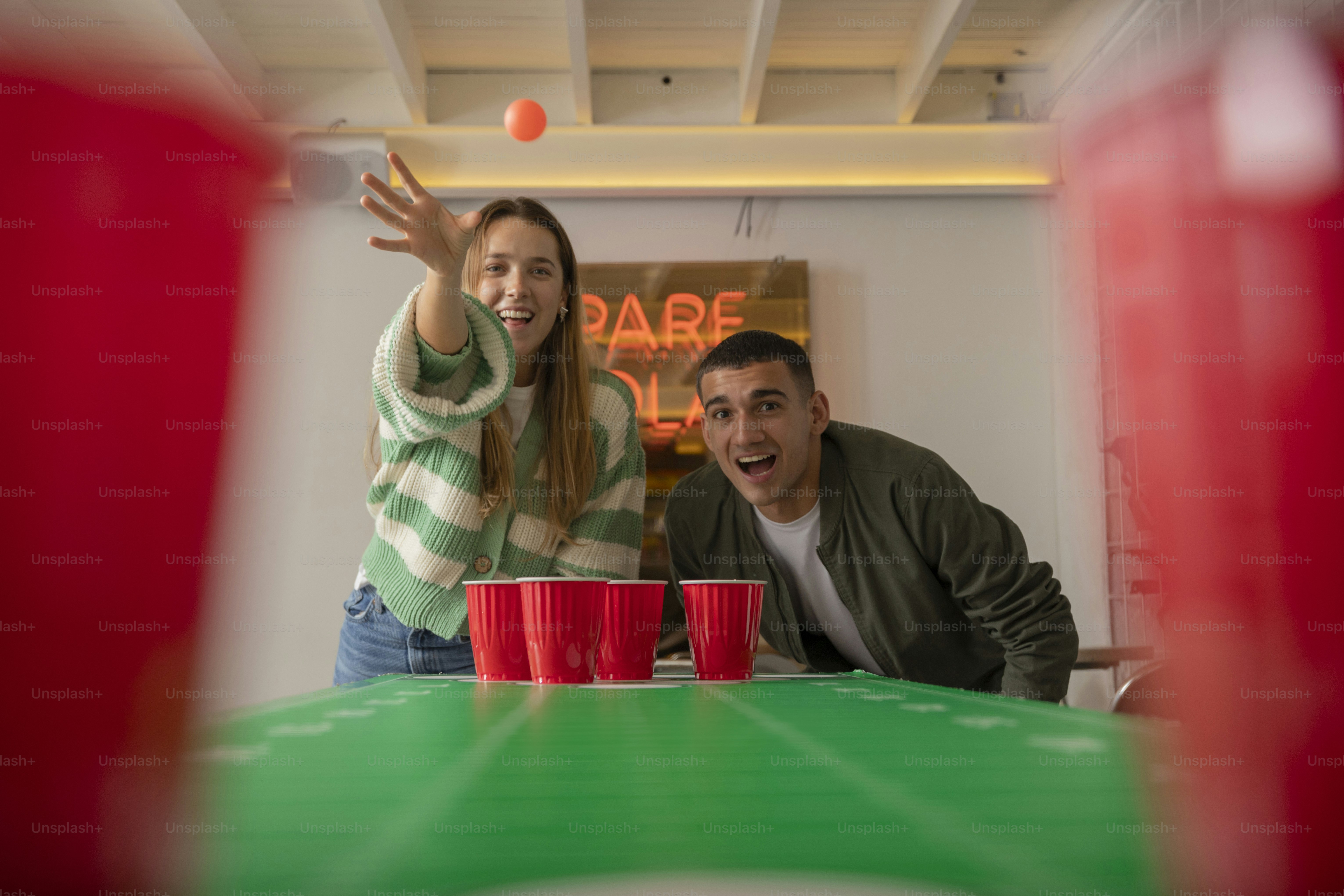 a man and a woman are playing a game of frisbee