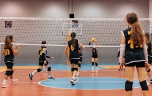 a group of girls playing a game of volleyball