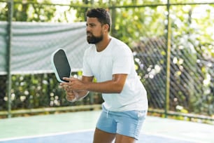 a man holding a tennis racquet on a tennis court