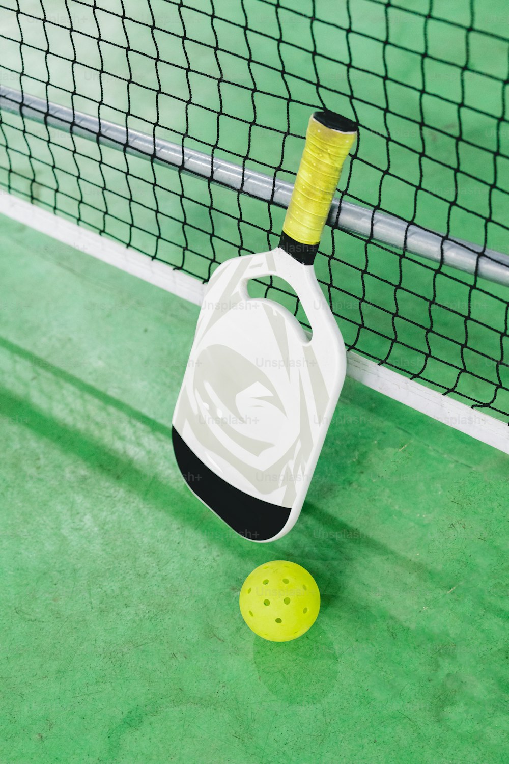 a tennis racket and ball on a court
