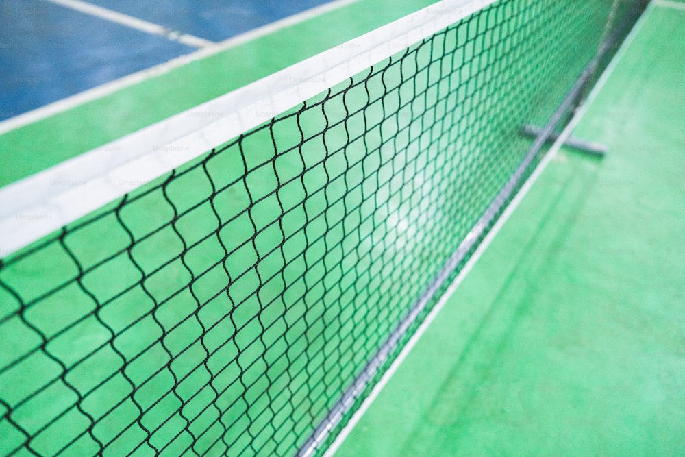 a close up of a tennis net on a tennis court