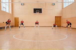 a group of young men playing a game of basketball