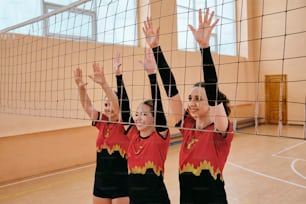 two girls are playing volleyball on a court