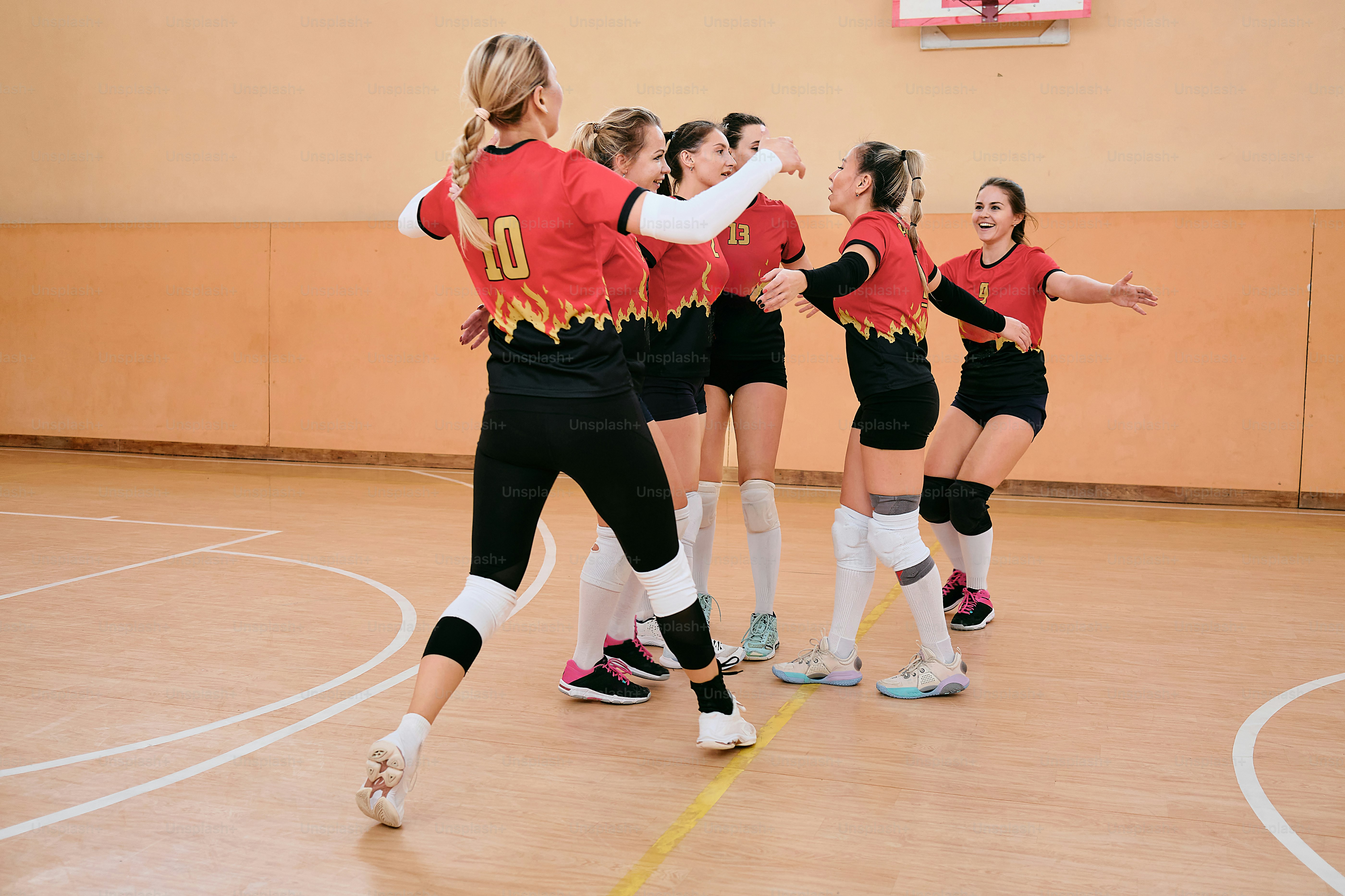 a group of young women playing a game of volleyball
