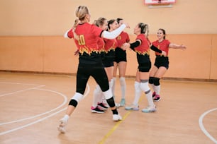 a group of young women playing a game of volleyball