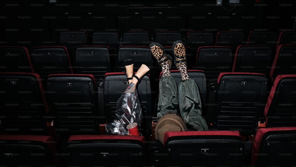 a couple of people that are sitting in a theater