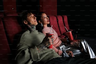 a man and a woman sitting in a movie theater