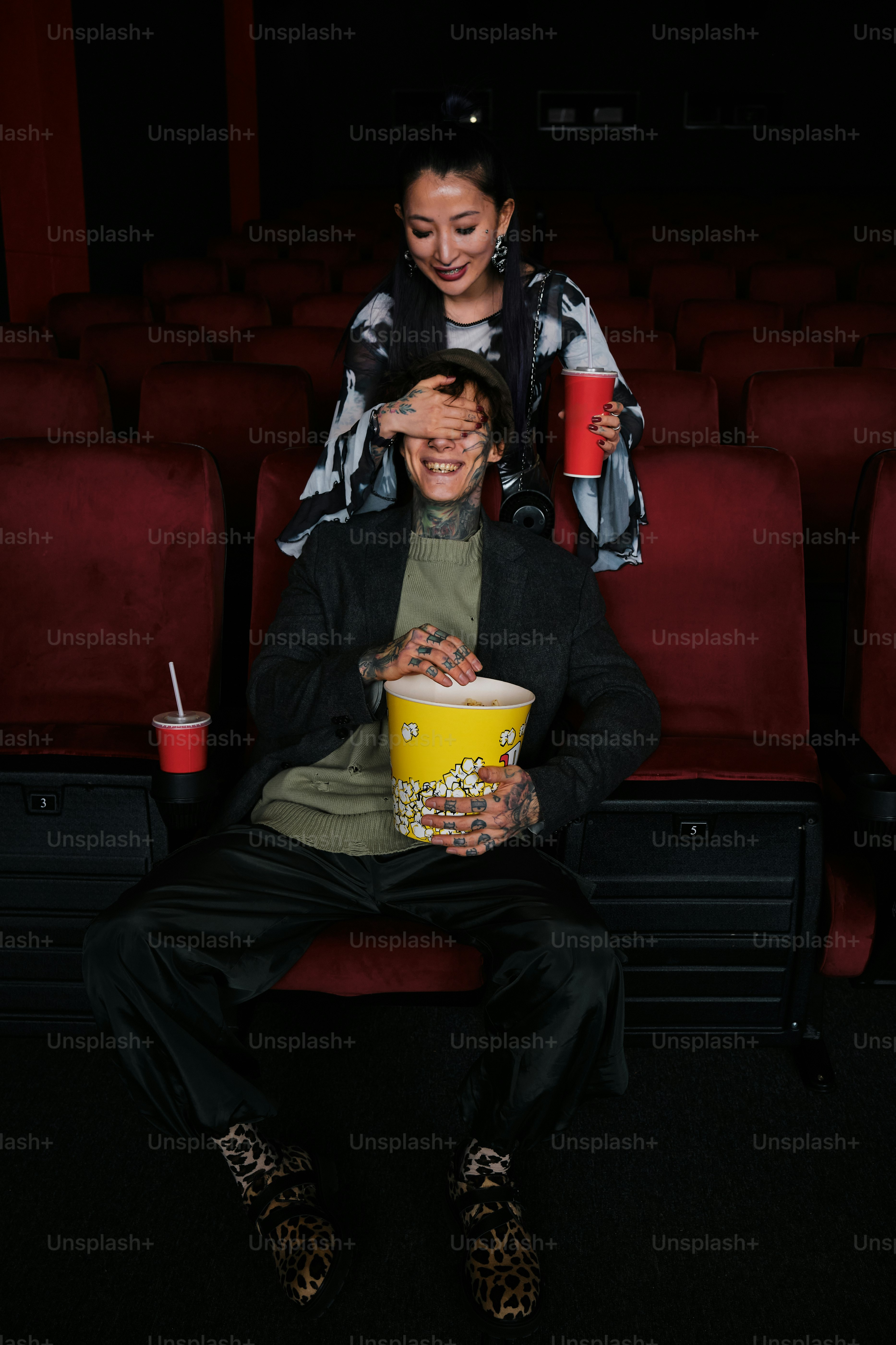 a man and a woman sitting in a movie theater