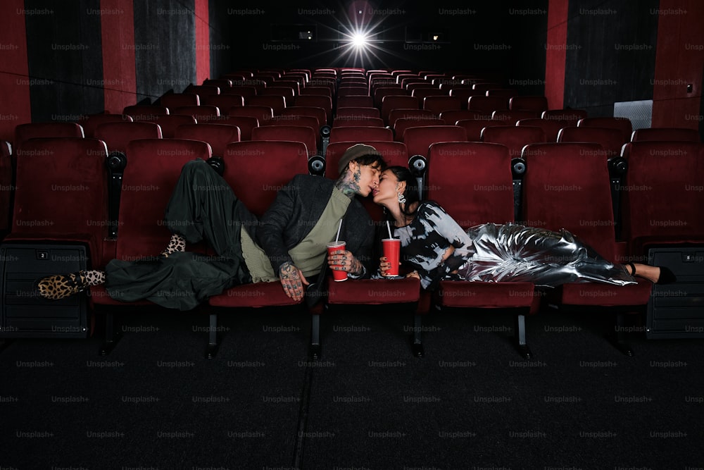 a man and a woman kissing in a theater