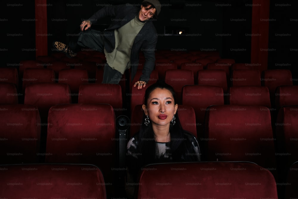 a man and a woman standing in a theater