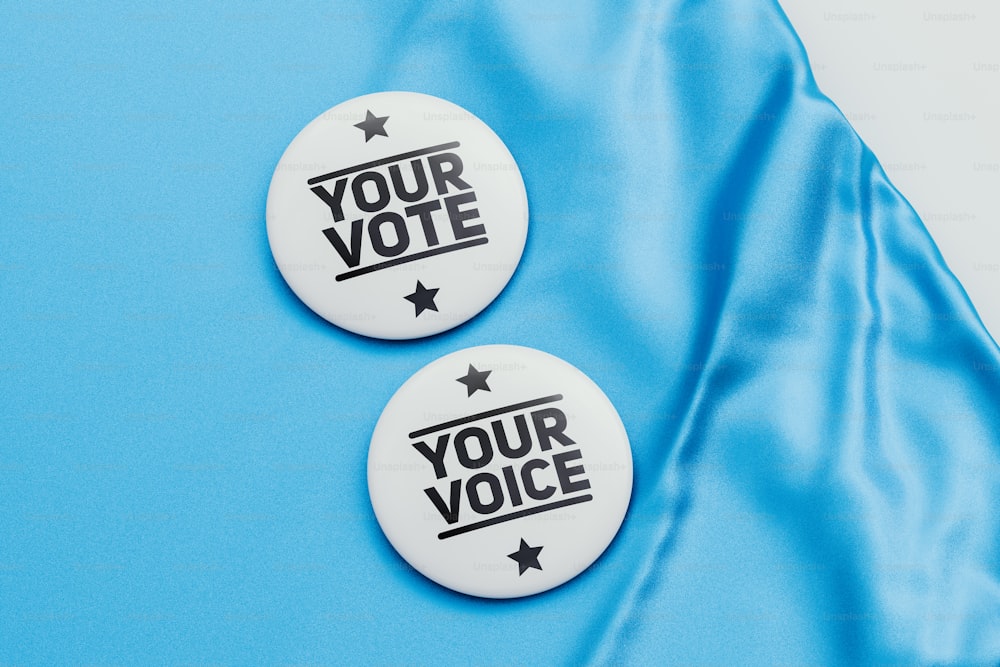 two buttons with the words your vote on them