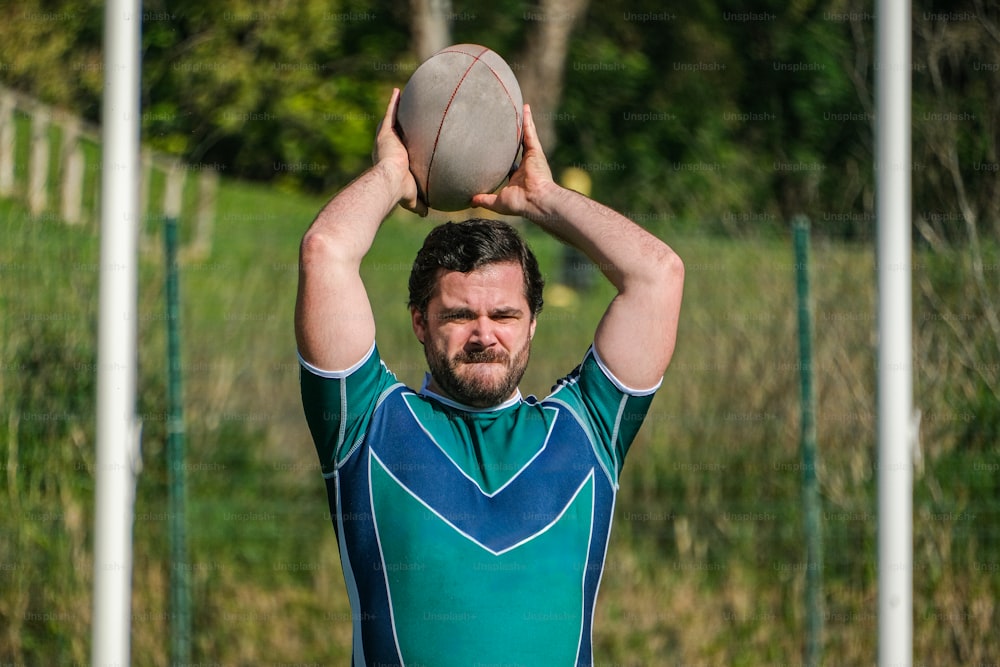a man holding a ball above his head