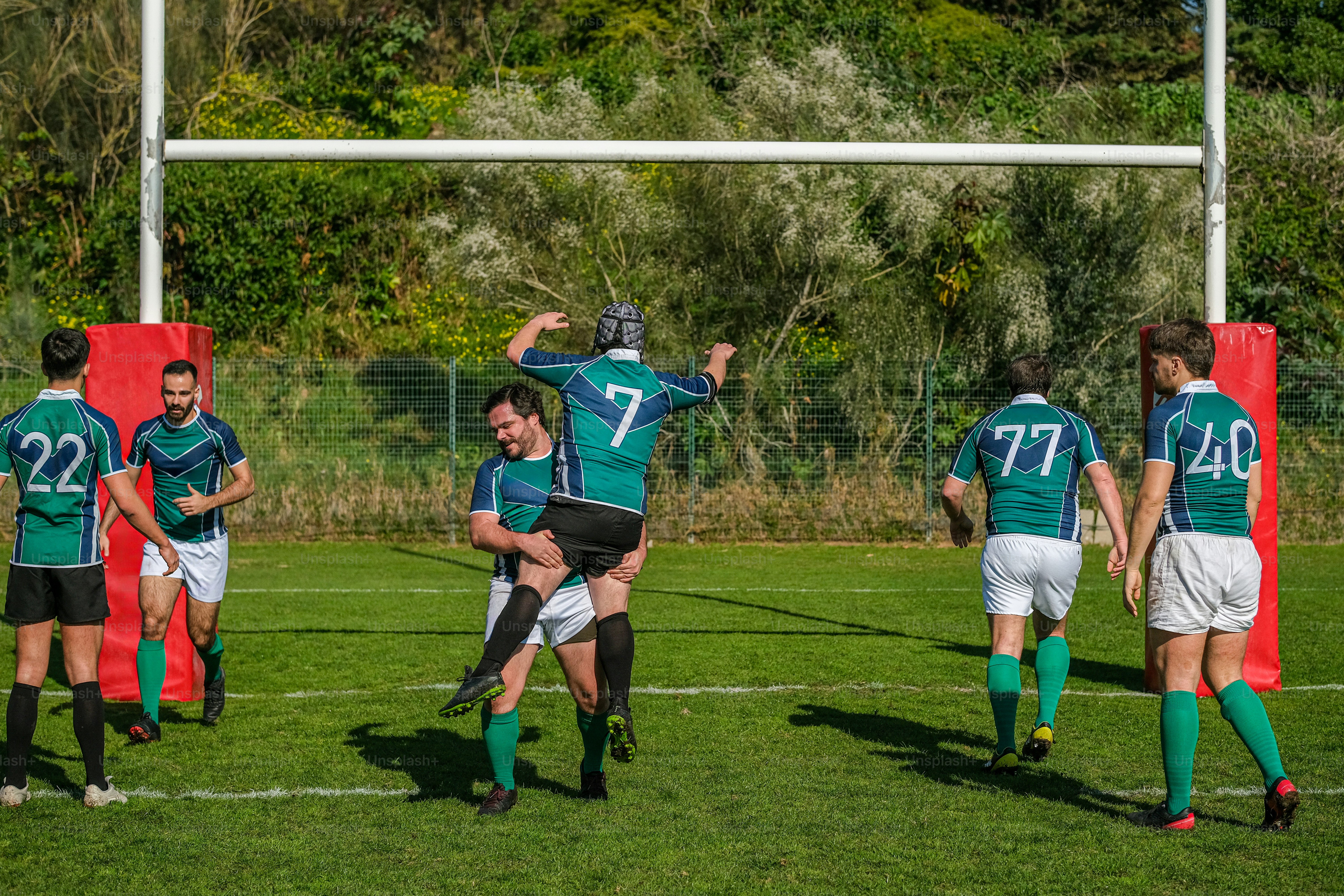 a group of men standing on top of a soccer field