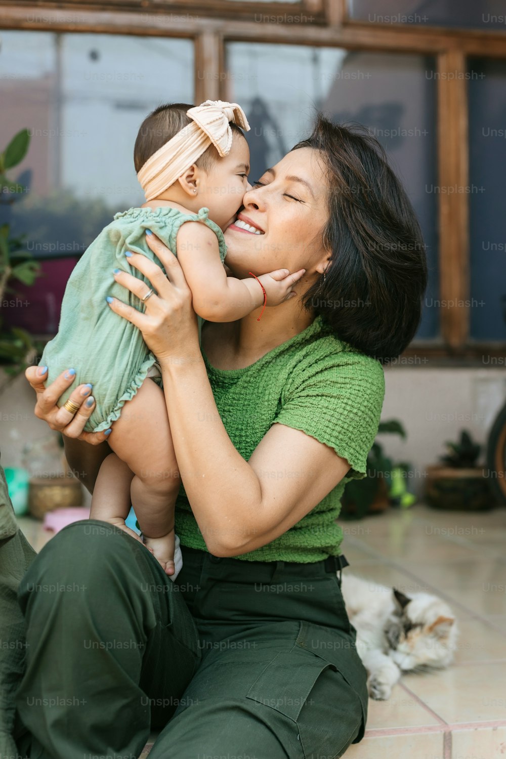 a woman is holding a small child in her arms