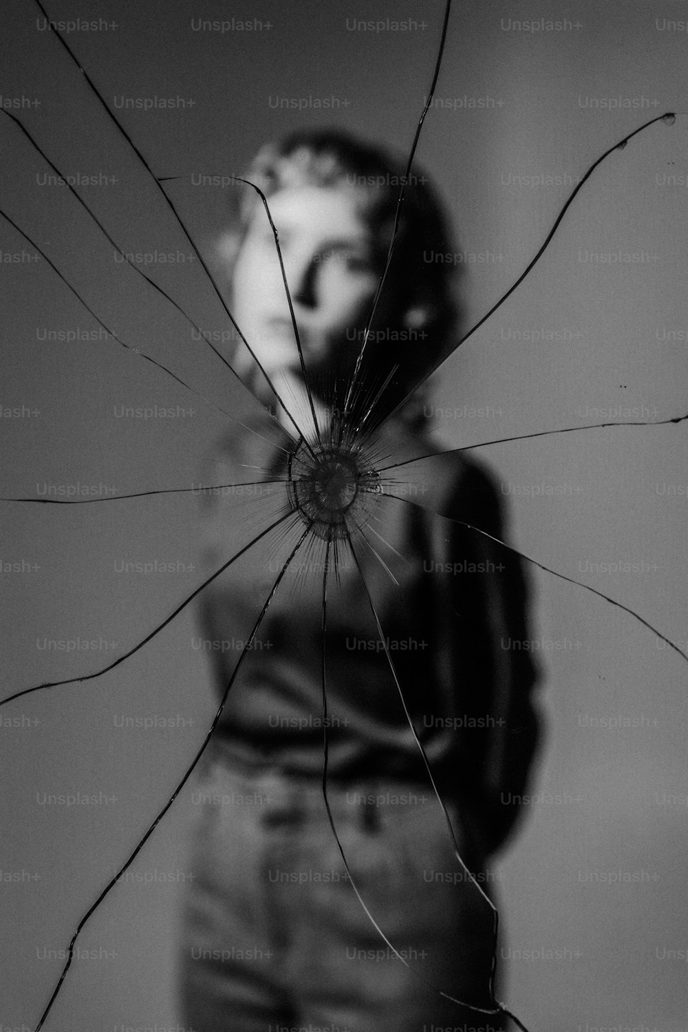 a woman standing in front of a broken window