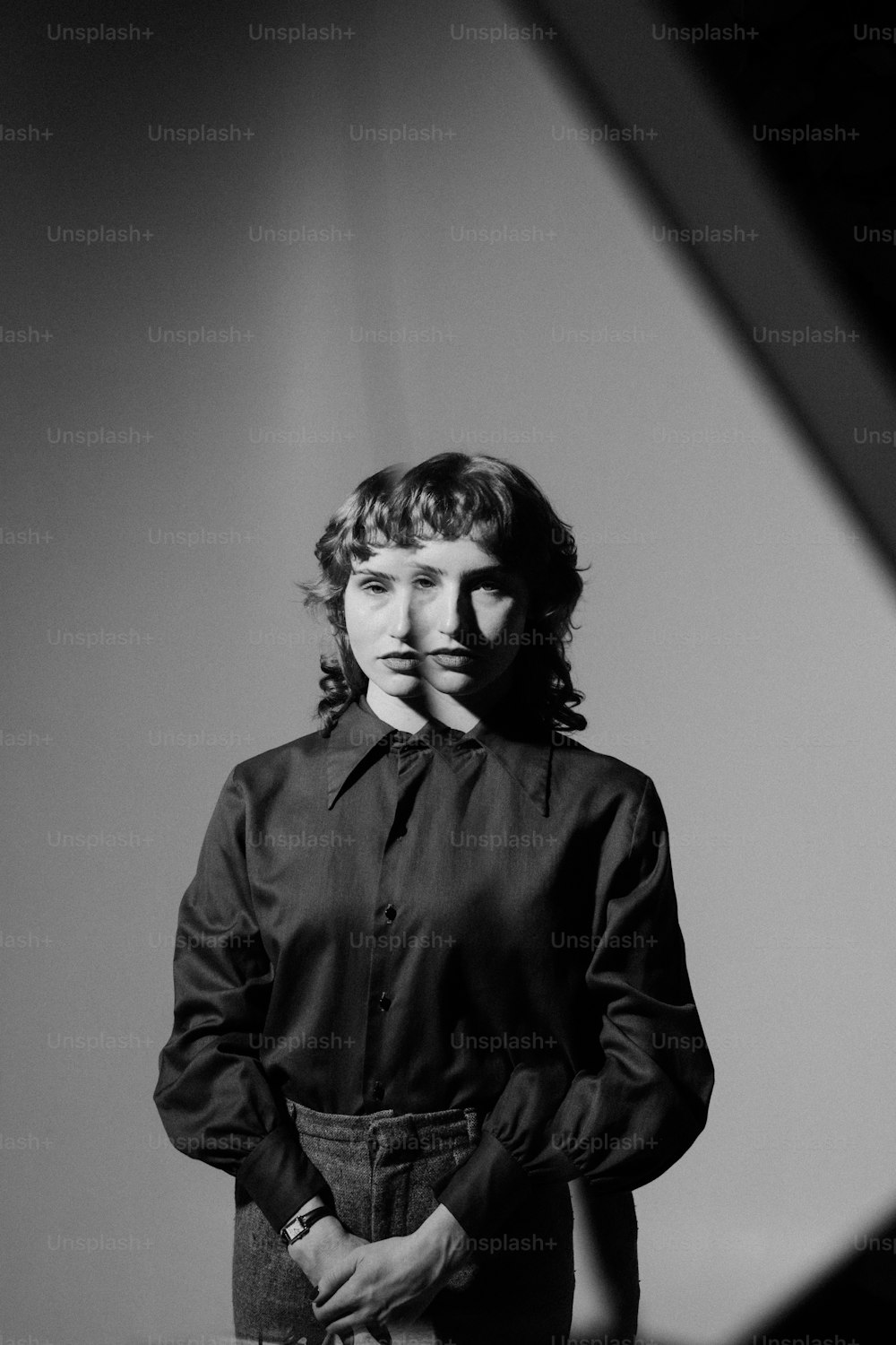 a black and white photo of a woman in a black shirt