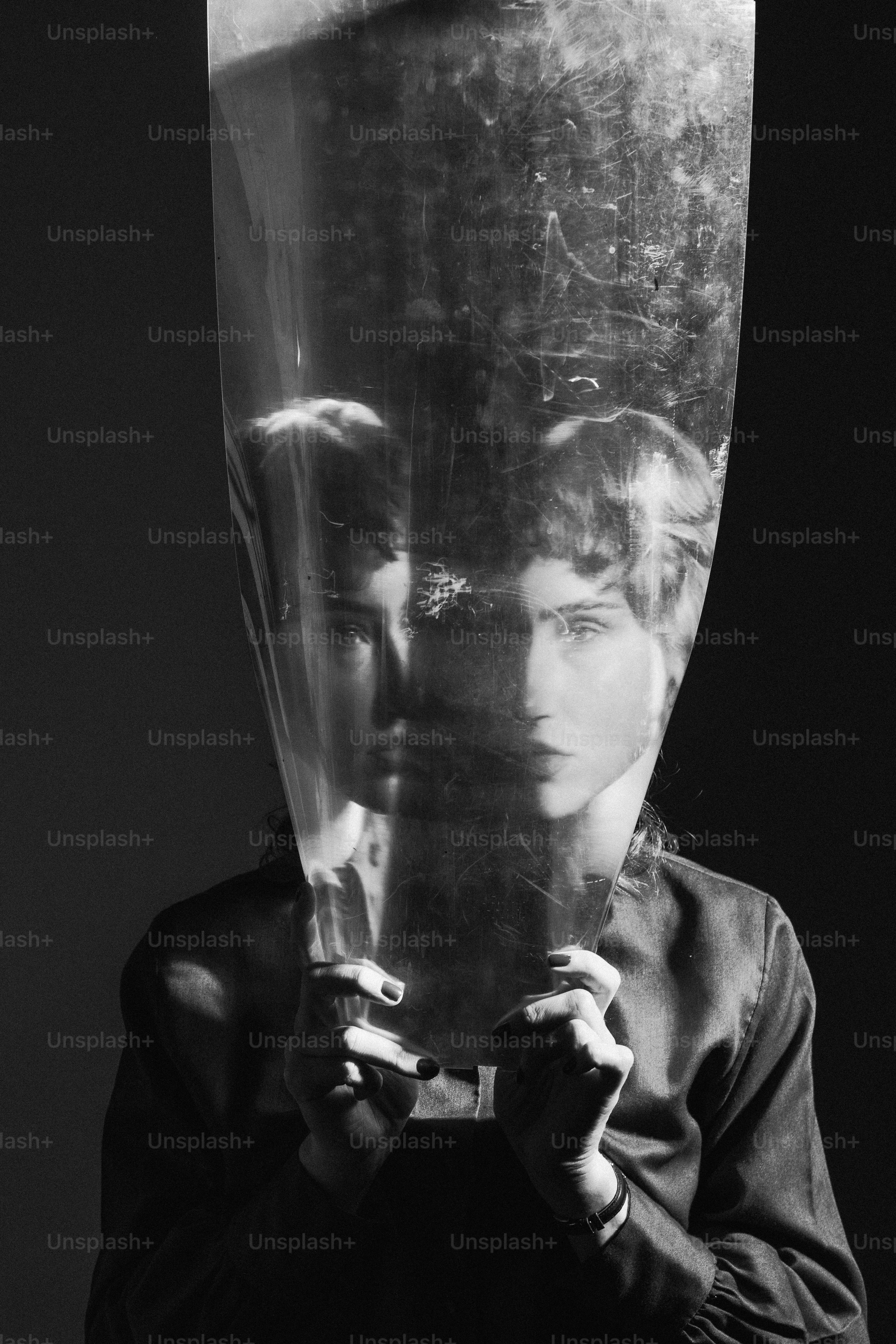 a woman holding a plastic bag over her face