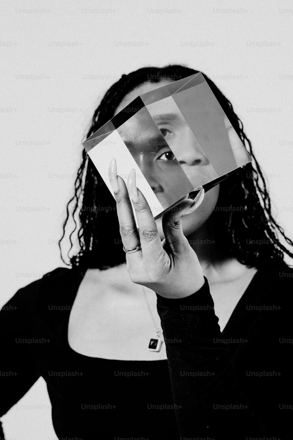 une femme tenant un morceau de papier sur son visage
