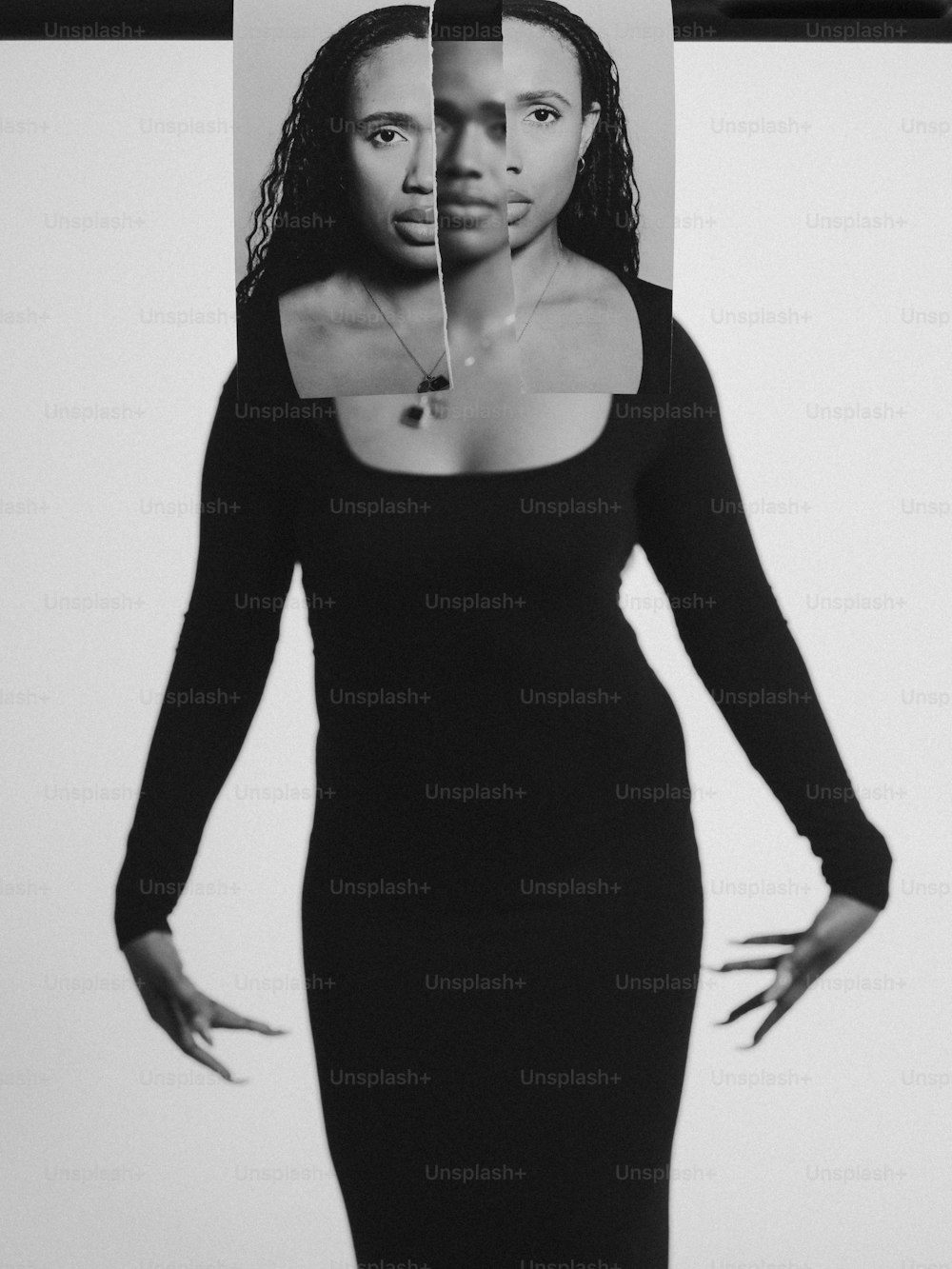 a woman in a black dress with a cut out of her face
