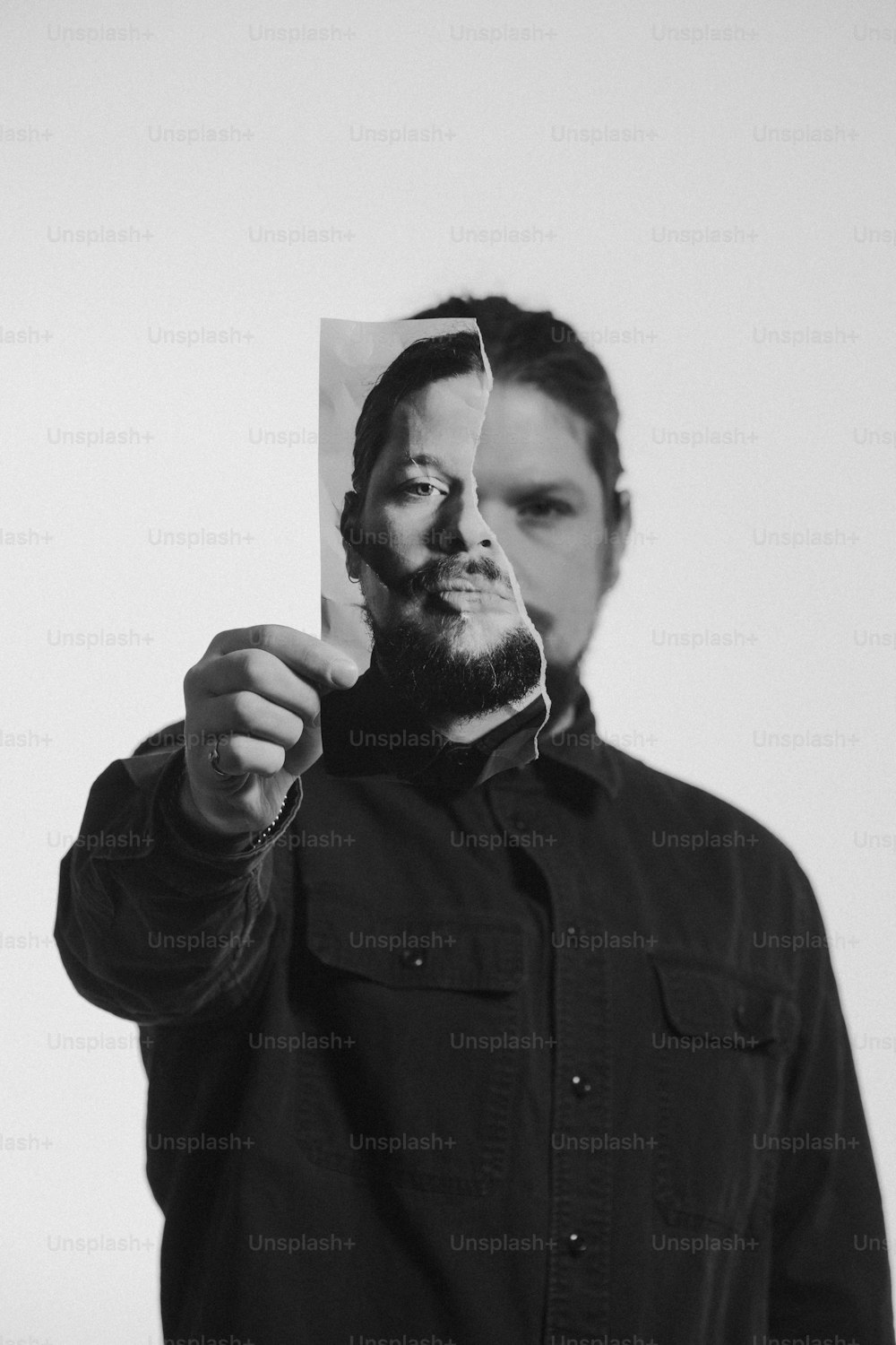 a man holding up a picture of himself