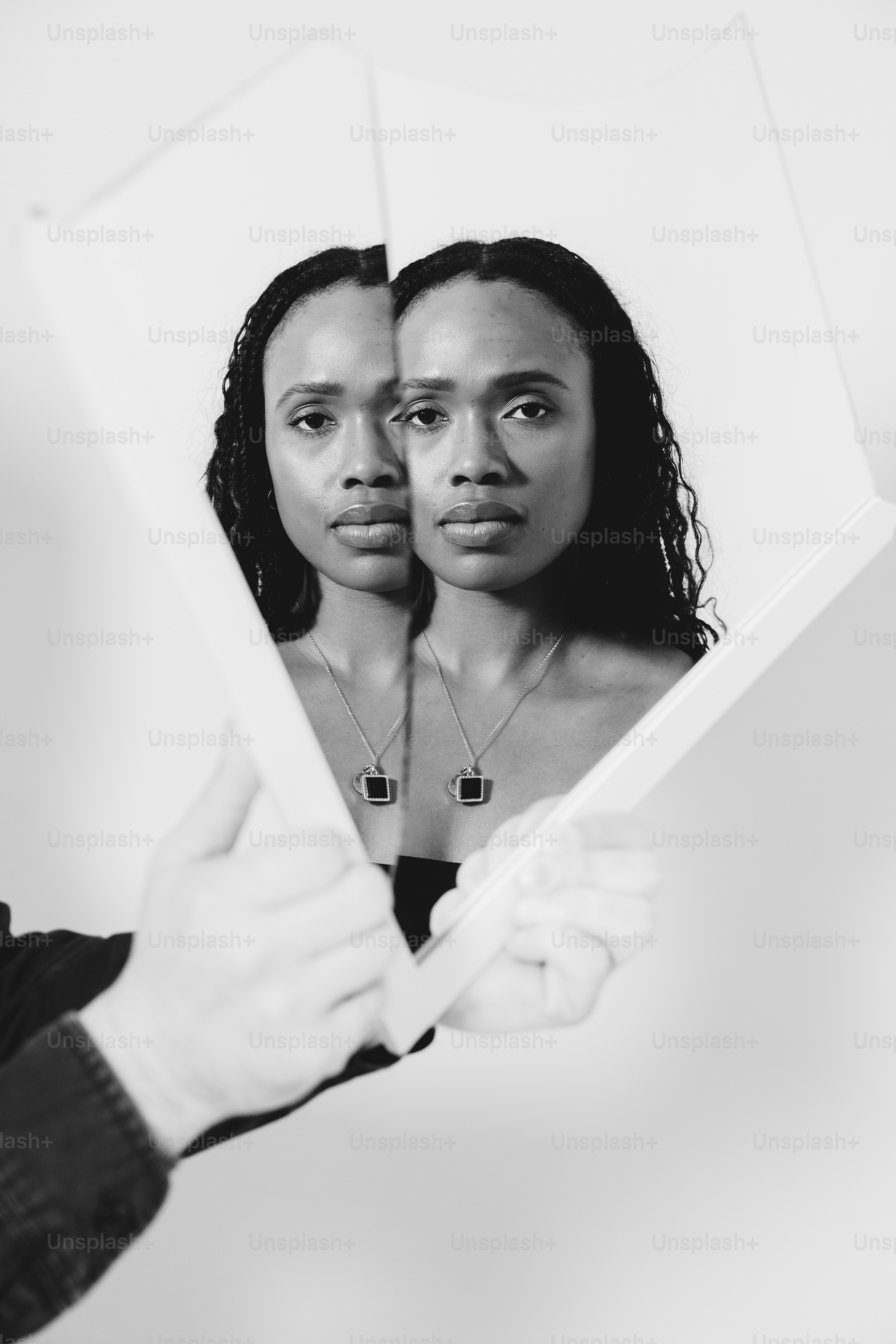 a man holding a mirror with a woman's face in it