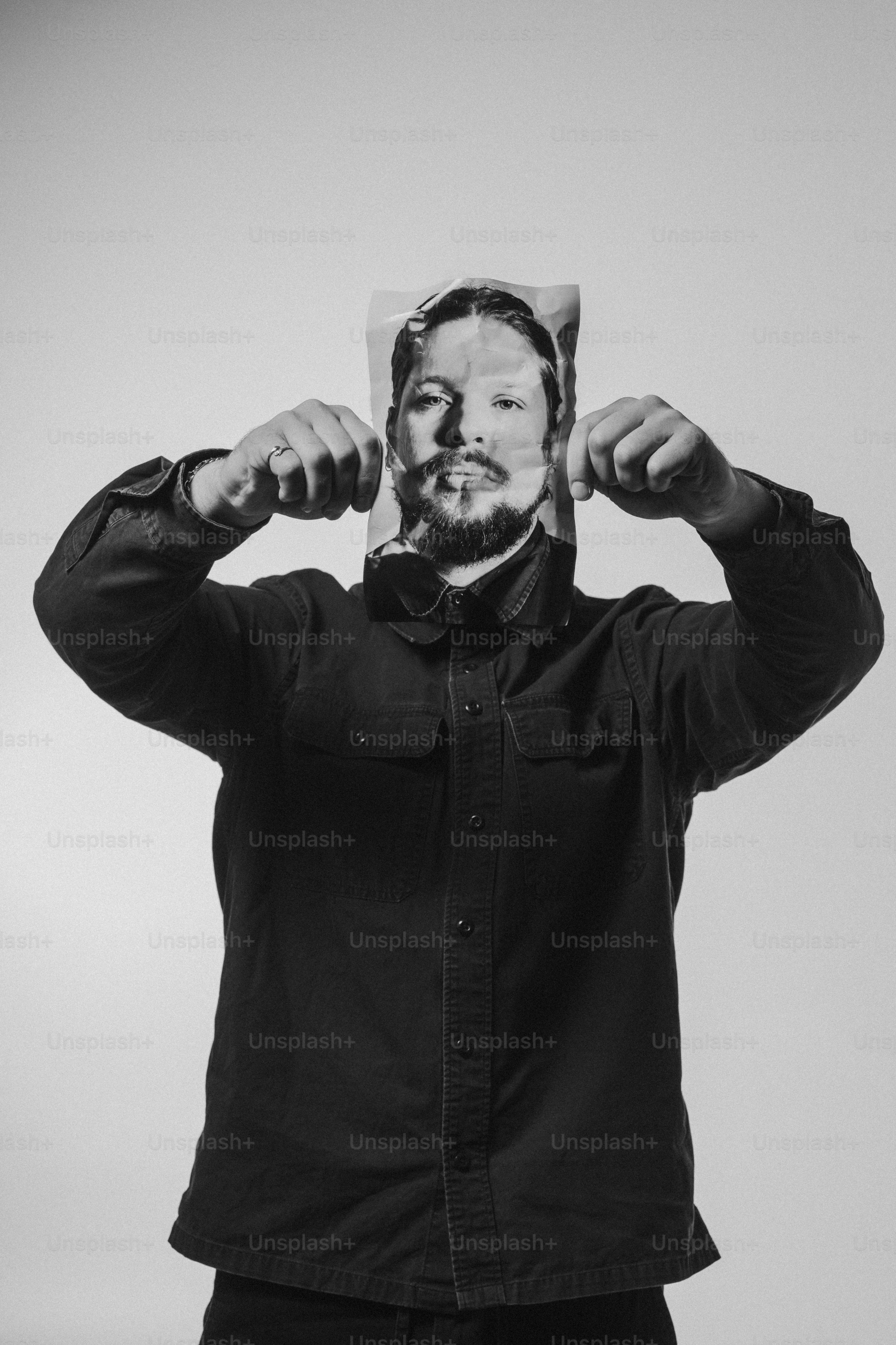 a man with a hat covering his face