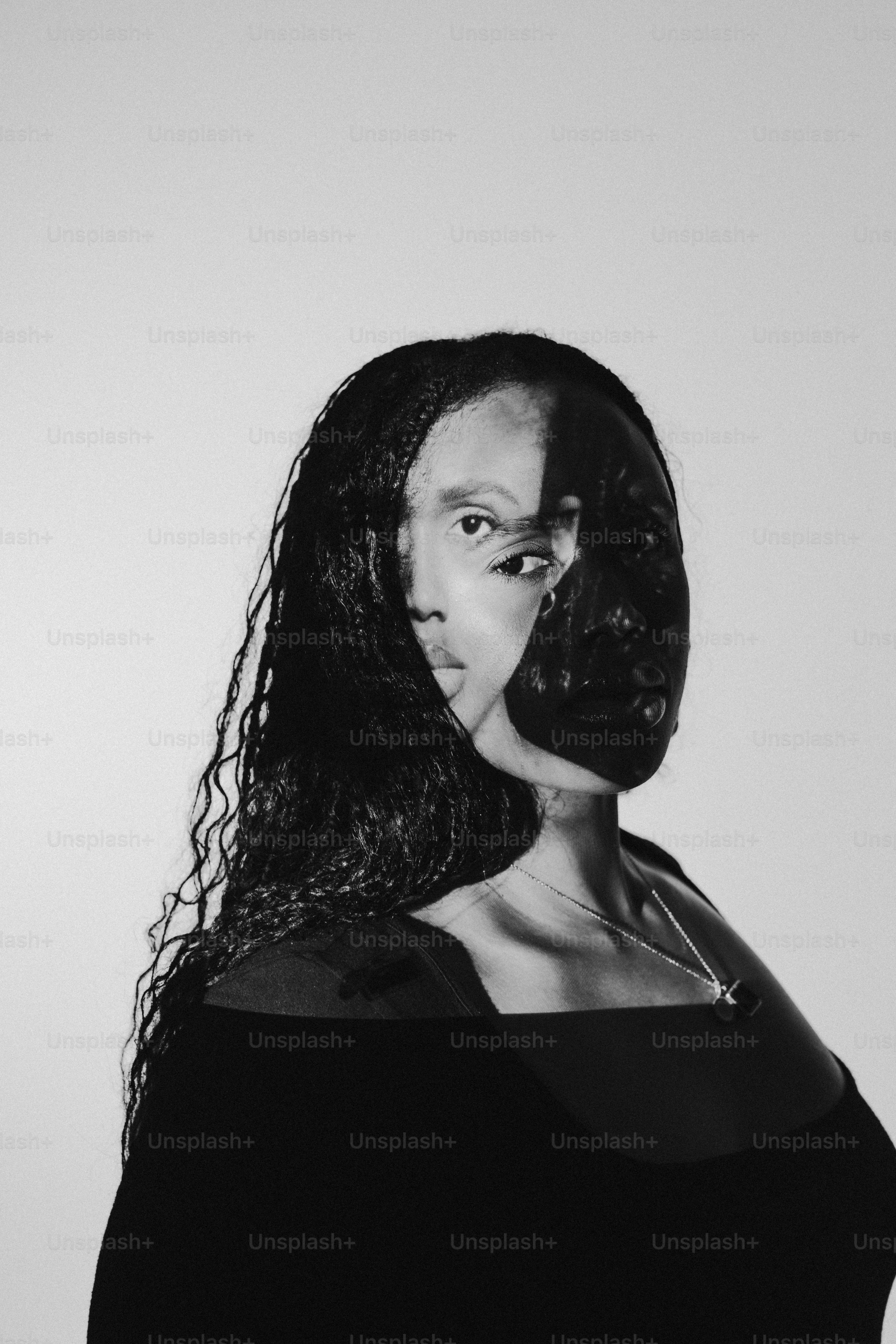 a black and white photo of a woman with long hair