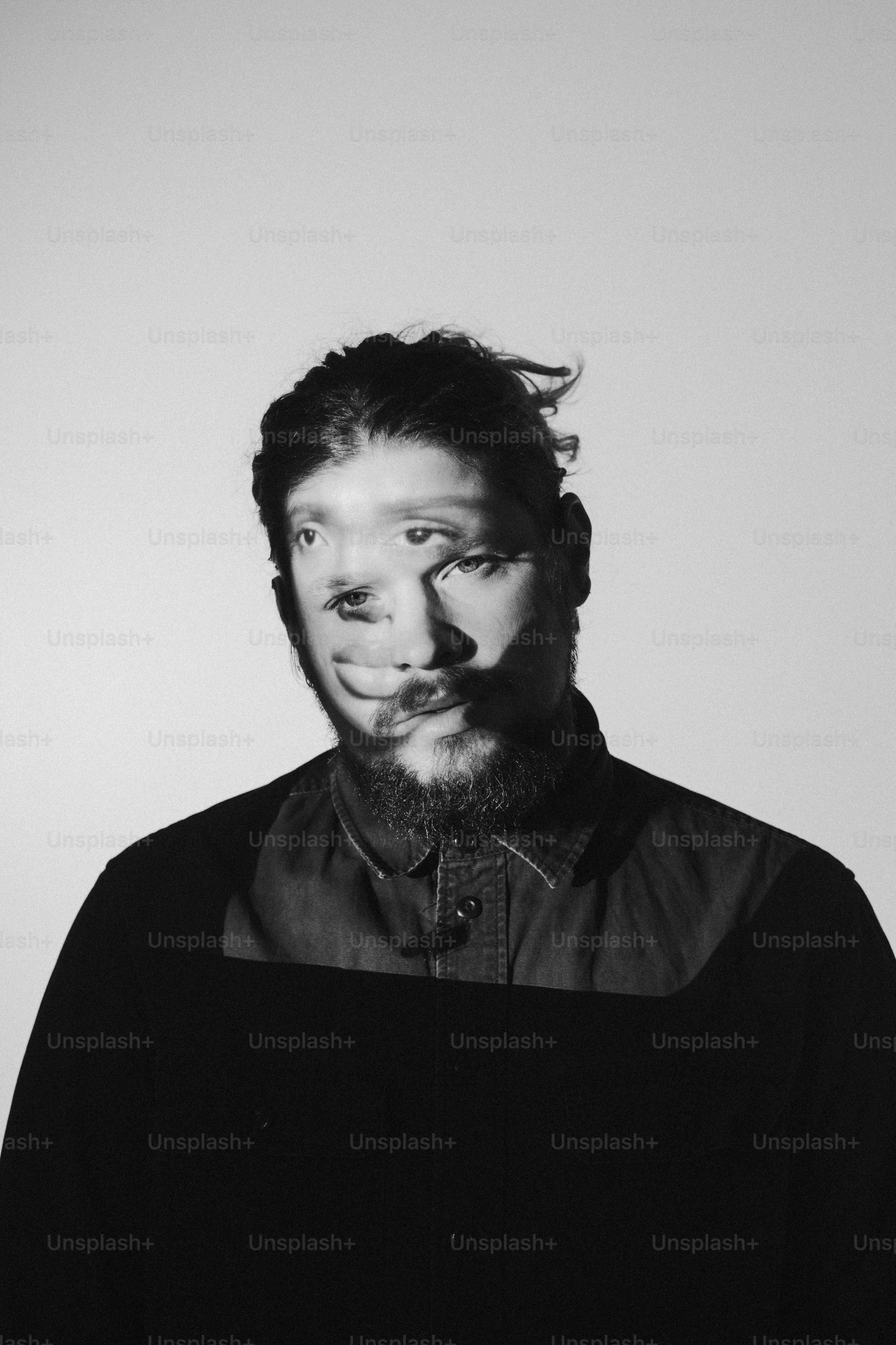 a black and white photo of a man with a beard