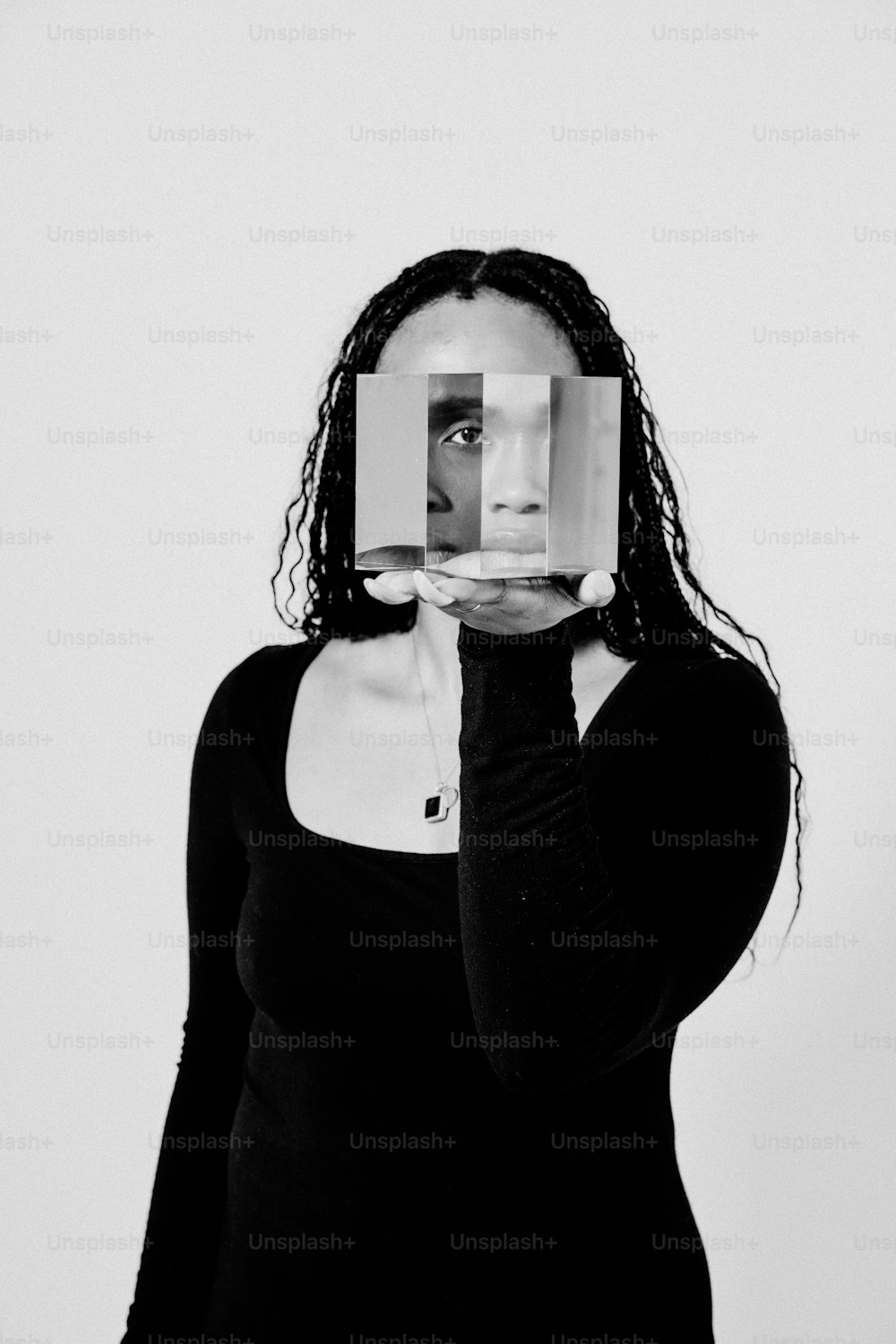 a woman covering her face with a piece of paper