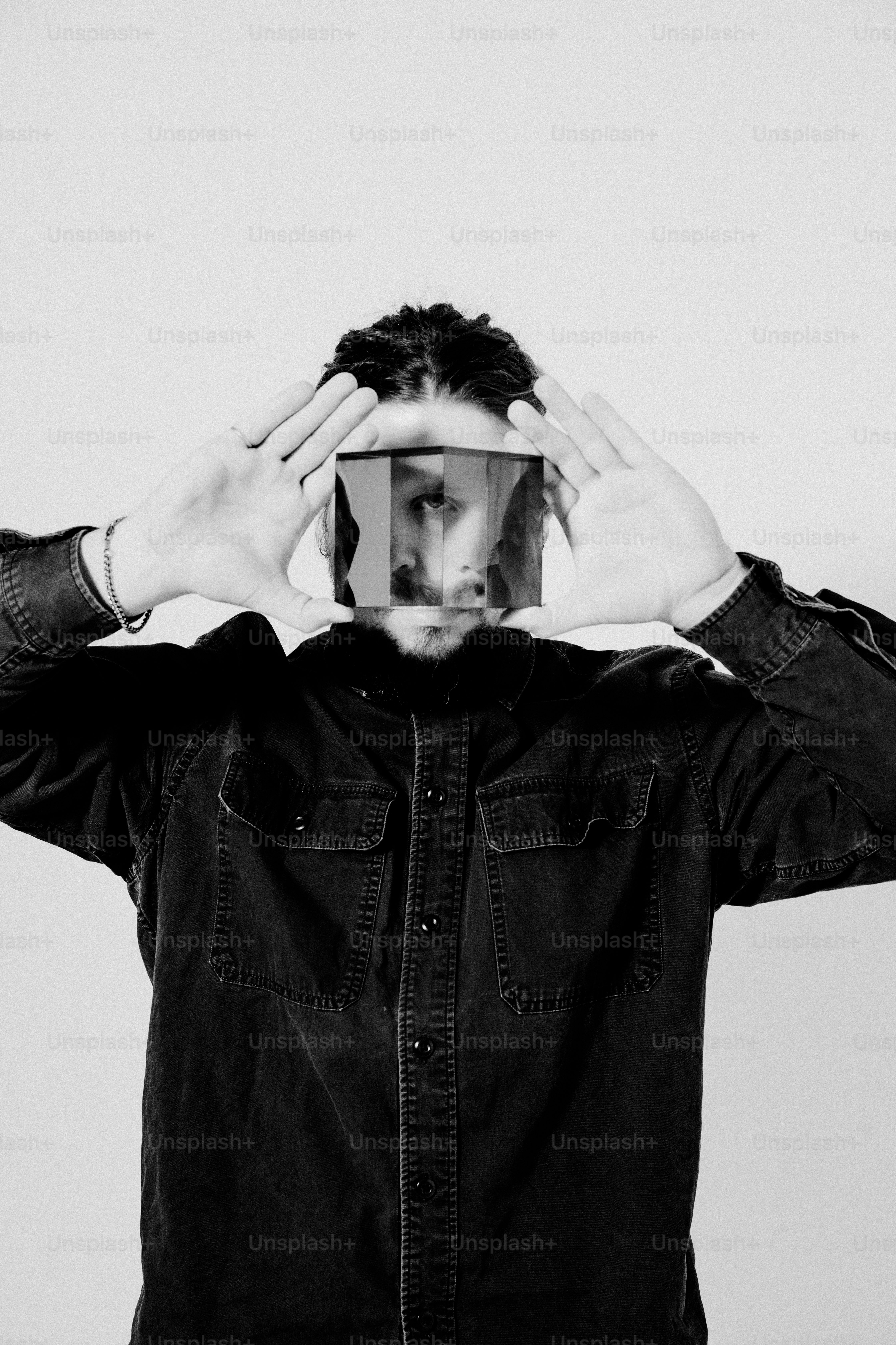 a man holding his hands up to his face