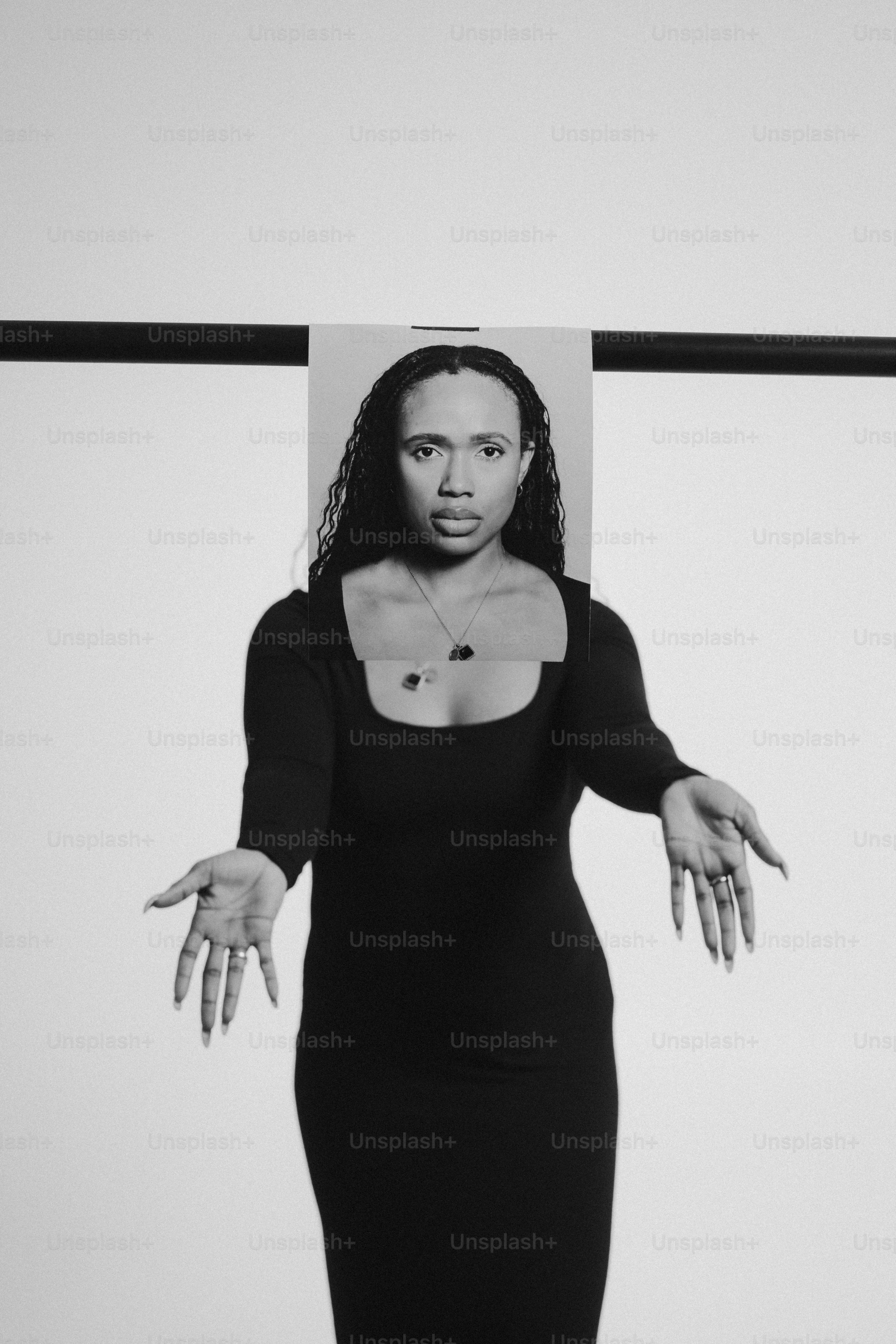 a black and white photo of a woman in a black dress