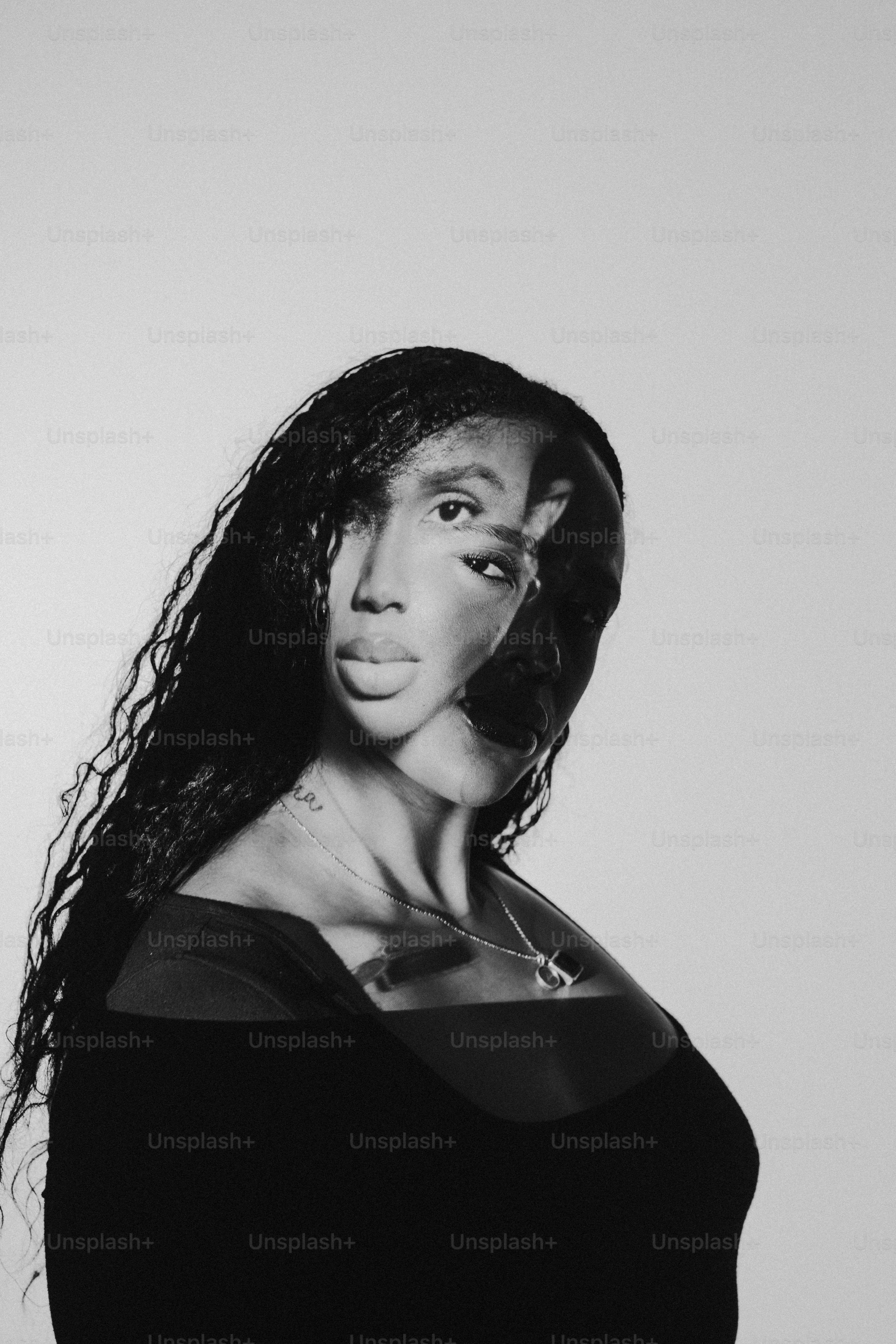 a black and white photo of a woman with long hair