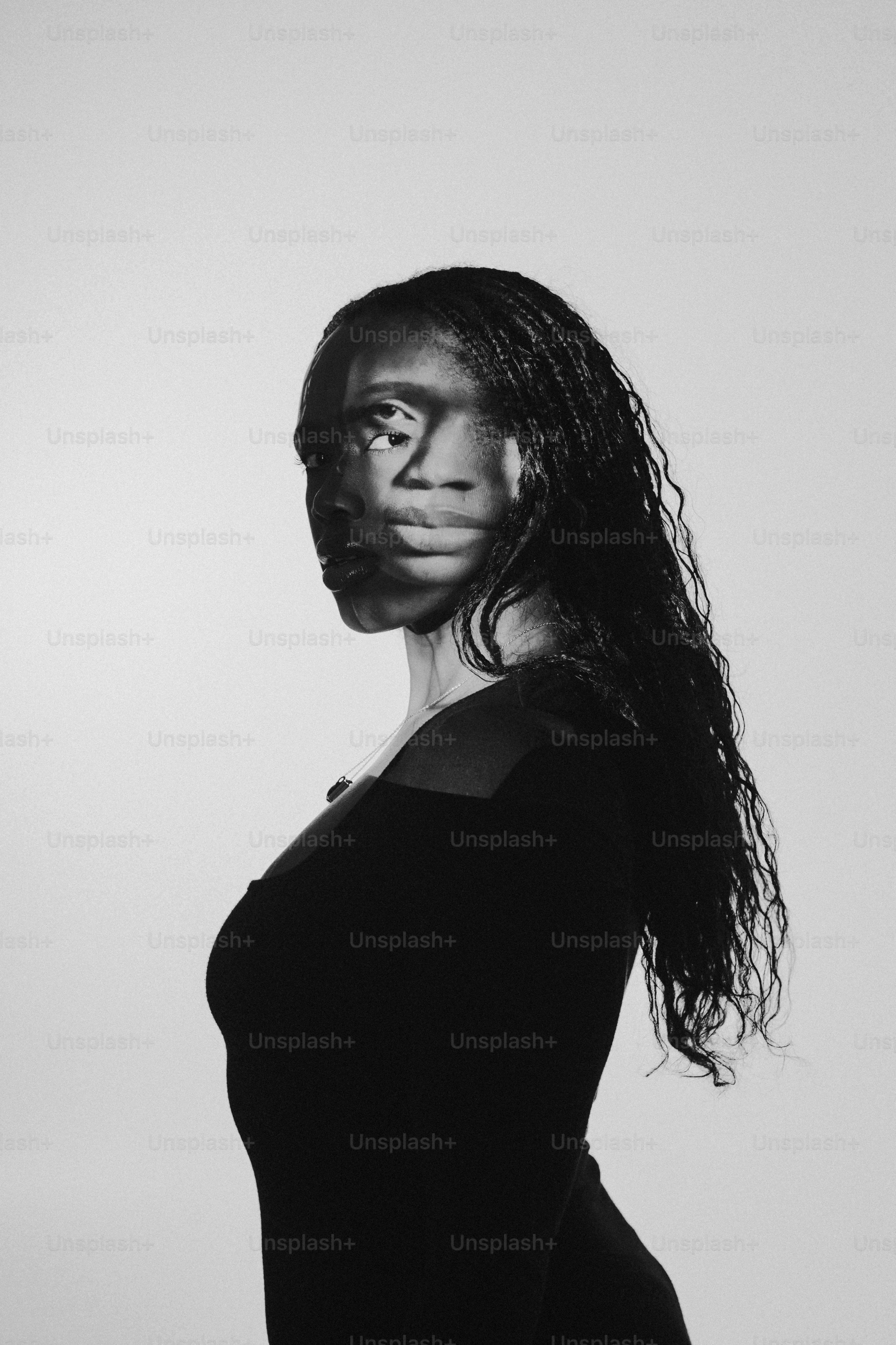 a black and white photo of a woman with long hair
