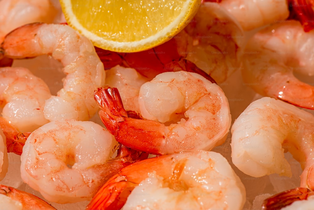 a close up of shrimp with a lemon wedge