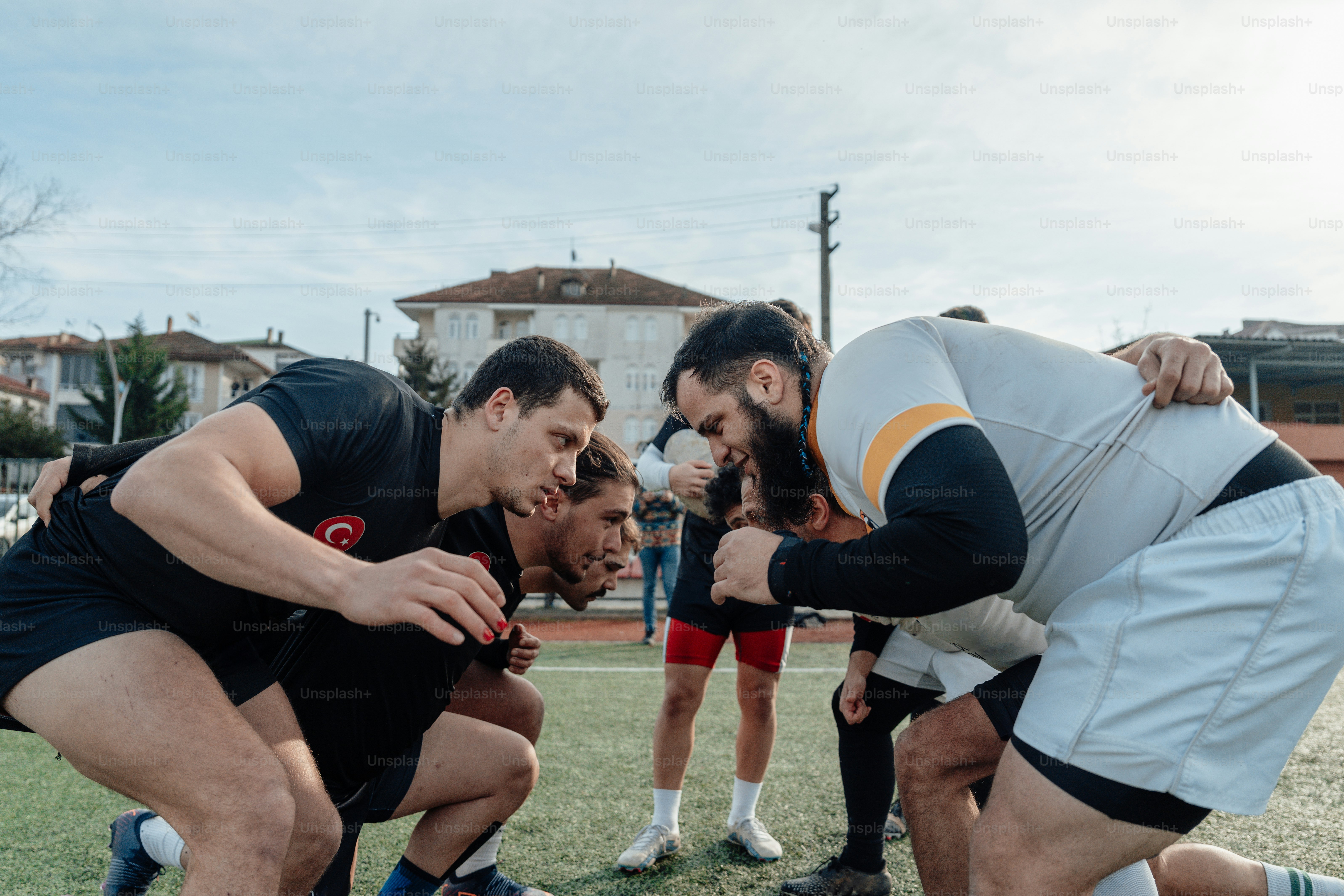 a group of men standing next to each other on a field