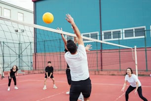 a group of people playing a game of volleyball