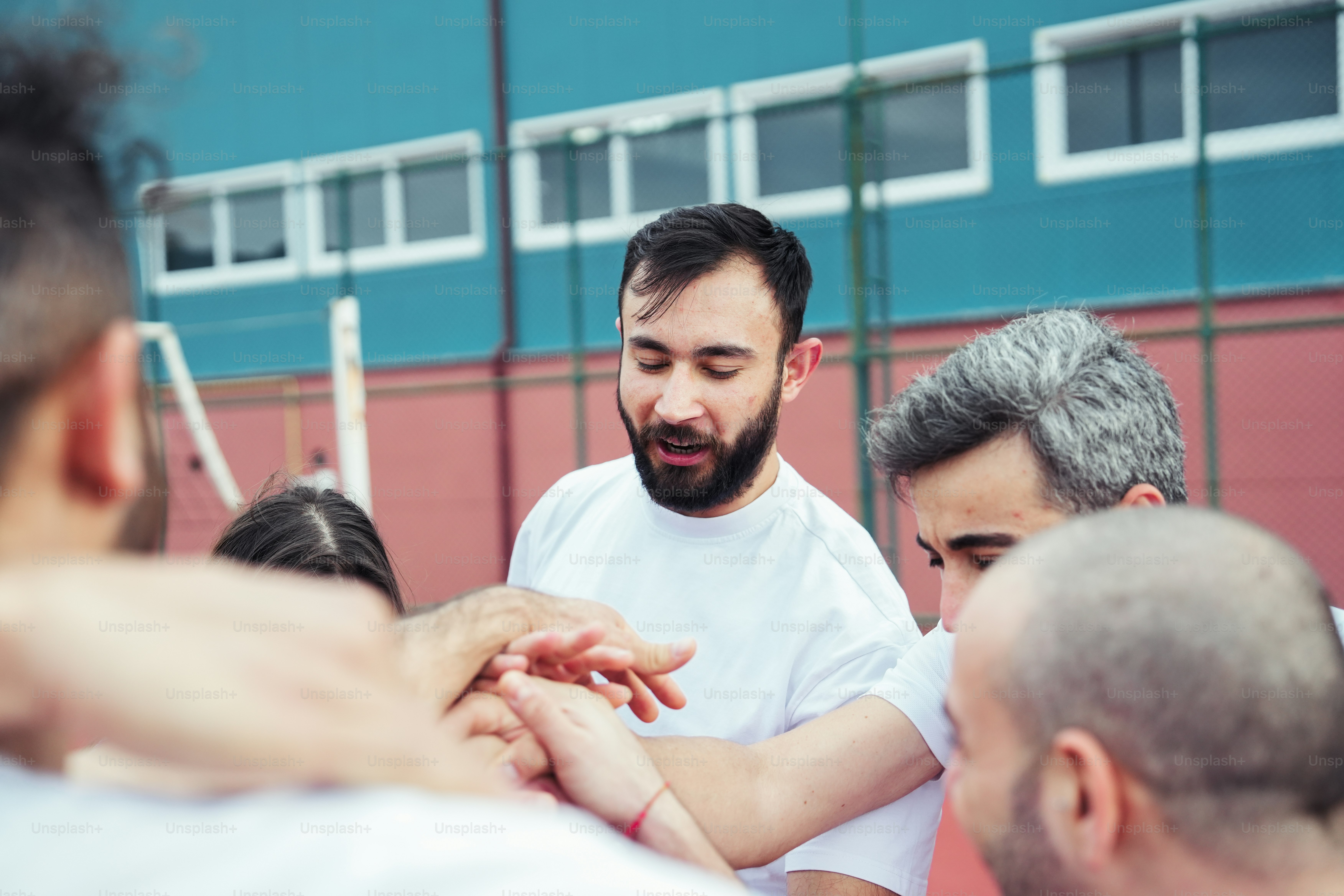a group of men standing around each other