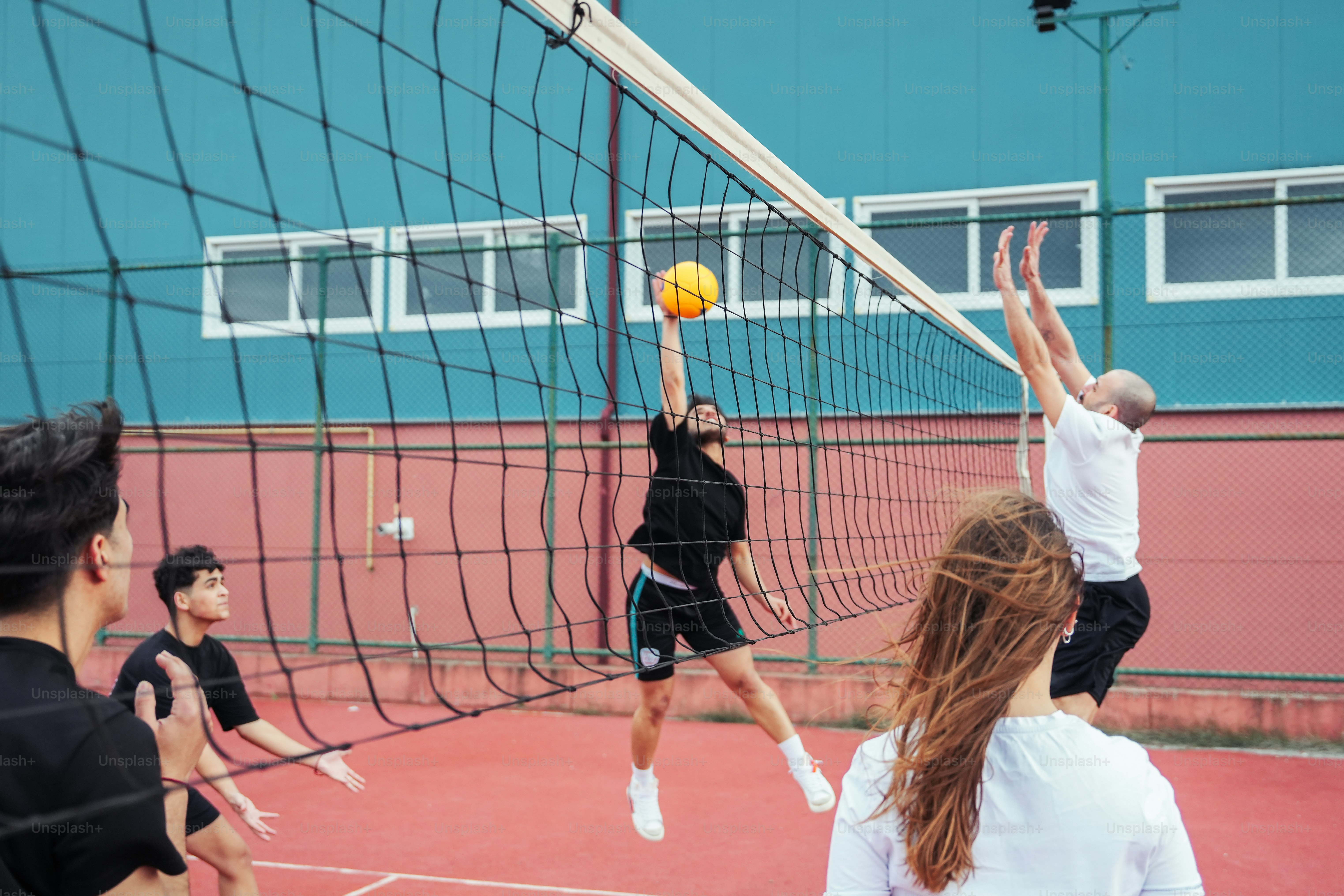 a group of people playing a game of volleyball