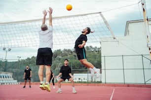 a group of men playing a game of volleyball