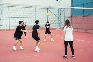 a group of young people playing a game of volleyball
