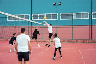 a group of people playing a game of tennis