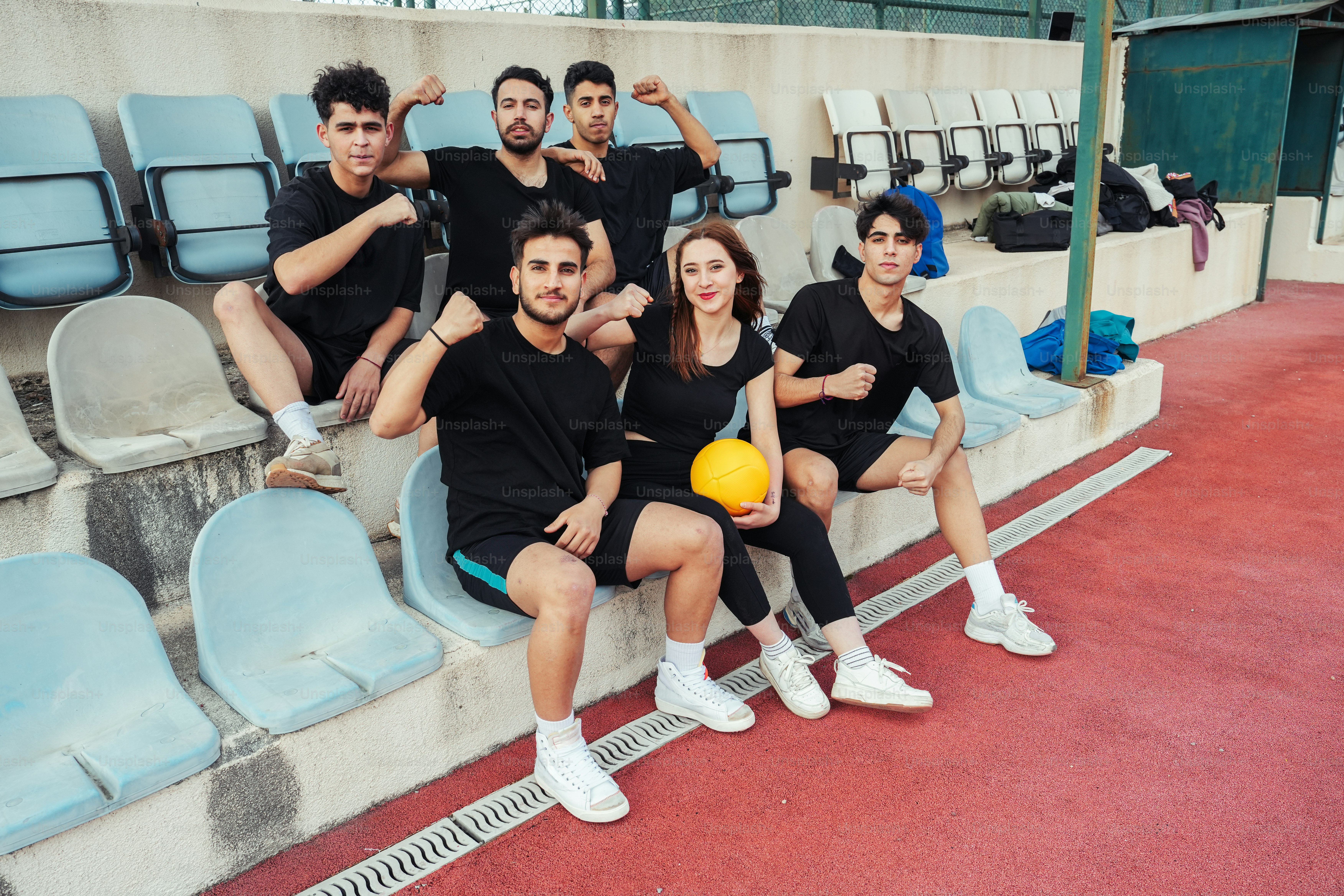 a group of people sitting next to each other on a bench
