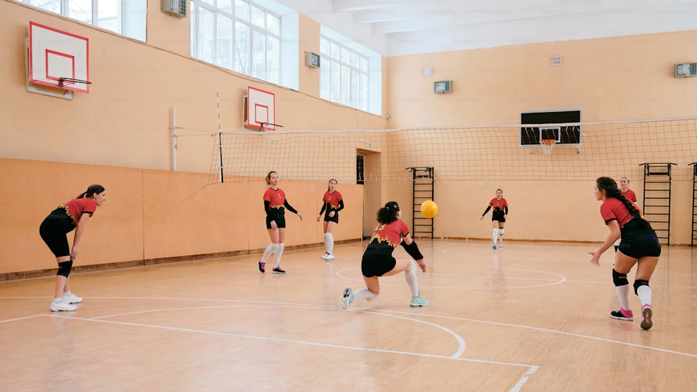 a group of young women playing a game of volleyball