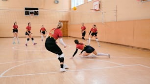 a group of women playing a game of volleyball