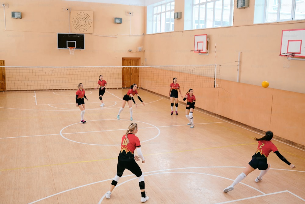 a group of women playing a game of volleyball