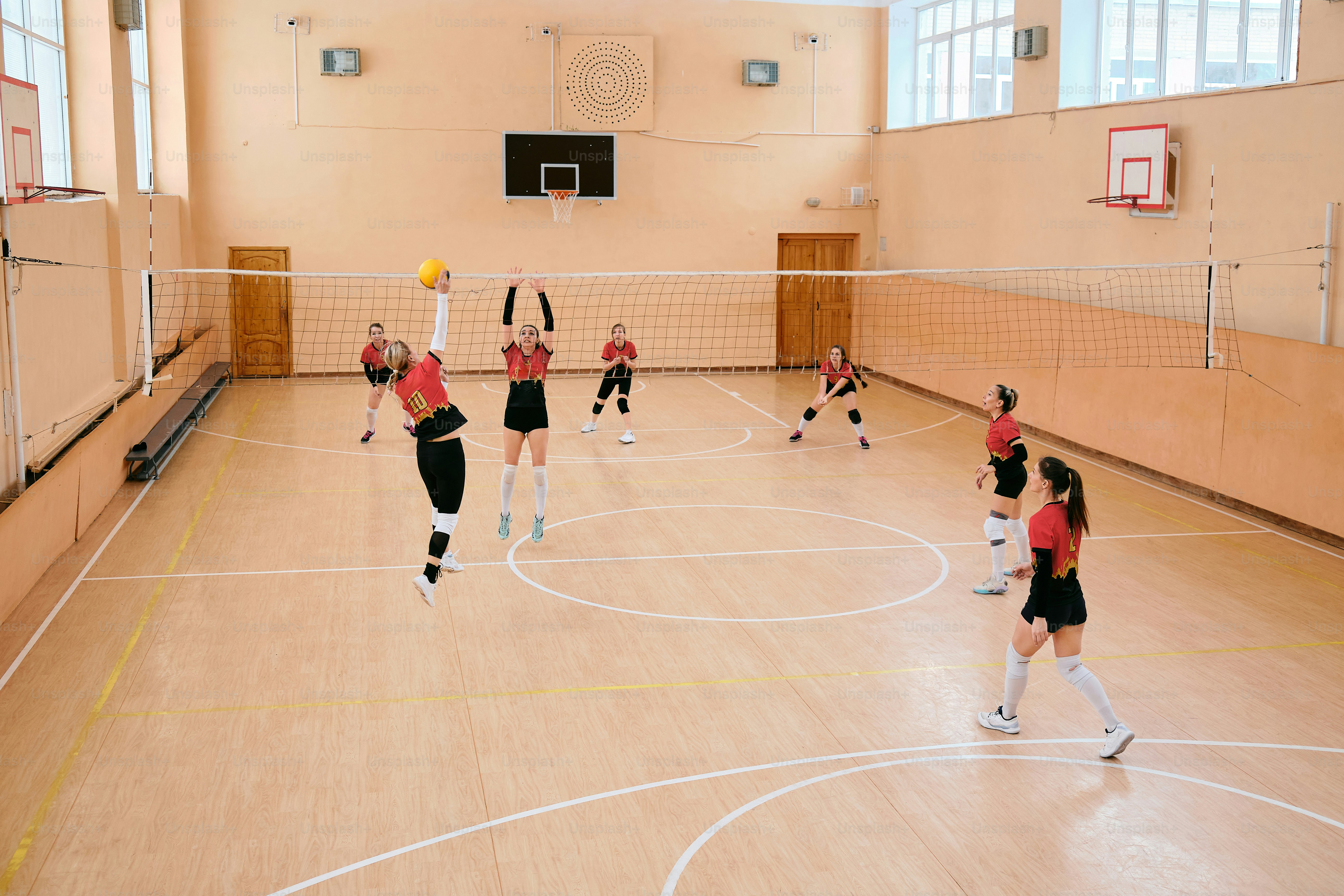 a group of people playing a game of volleyball