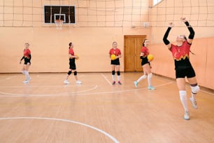a group of women playing a game of volleyball