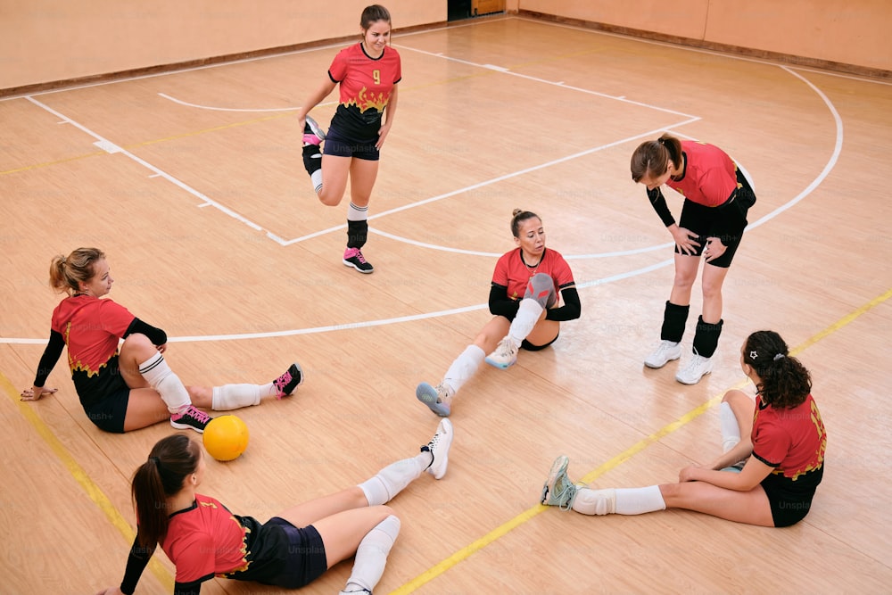 a group of young women playing a game of volleyball