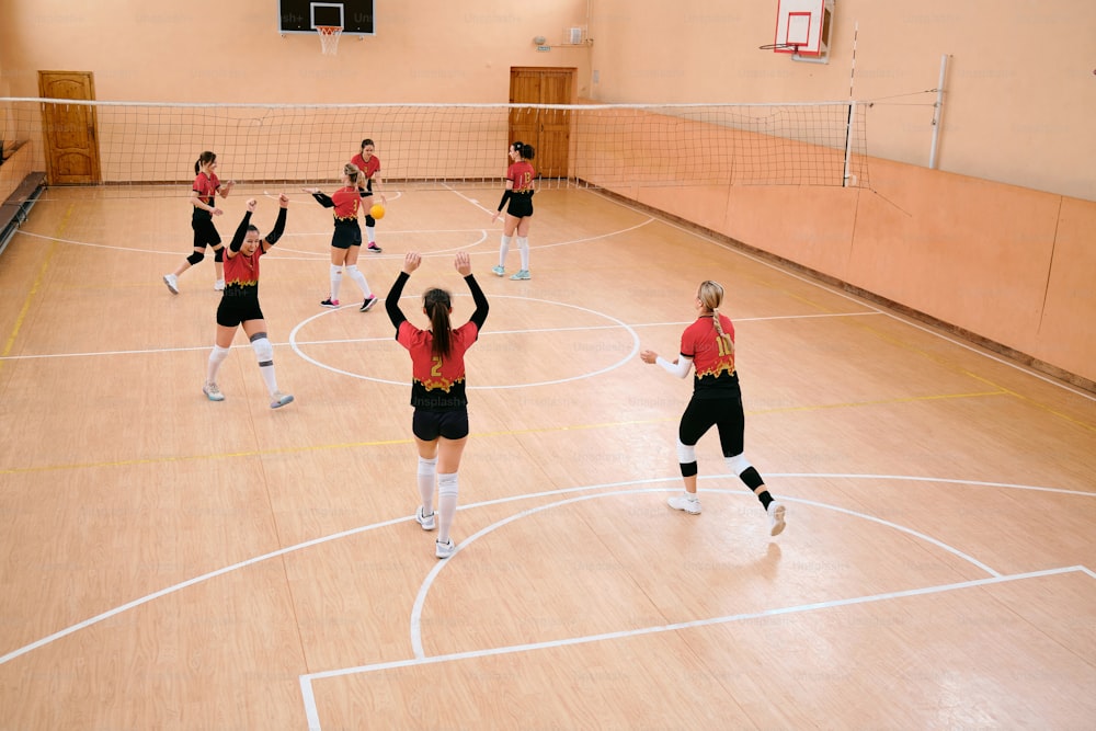 a group of young people playing a game of volleyball