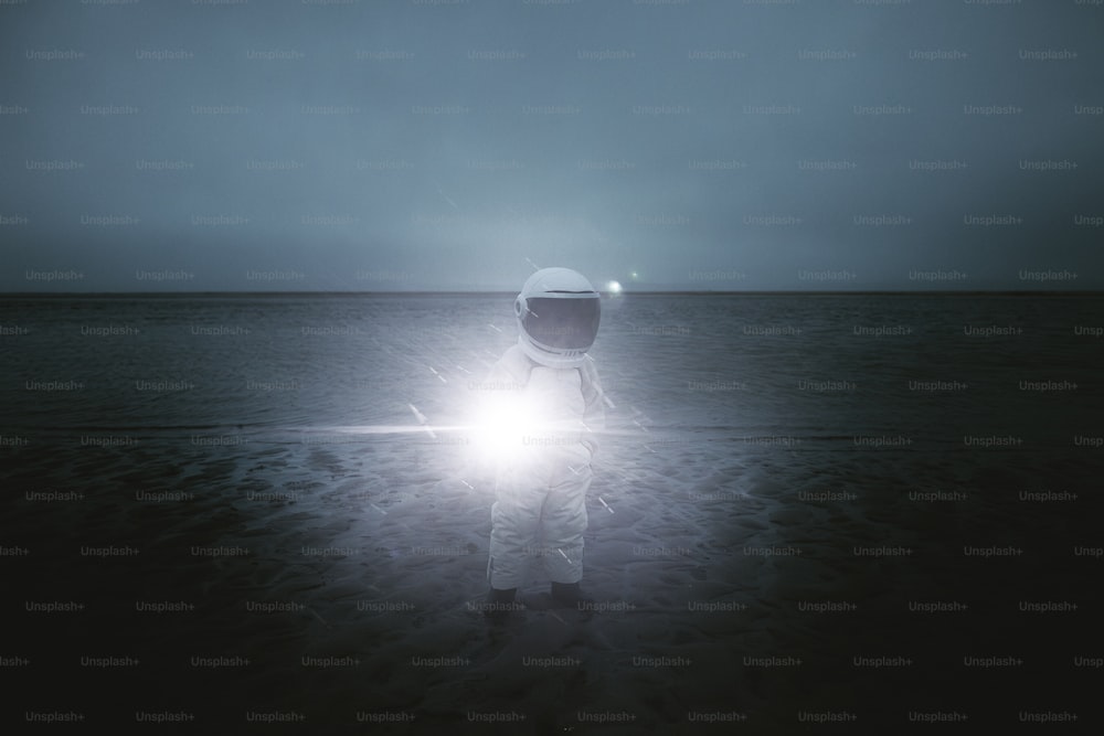 a man in a space suit standing on a beach